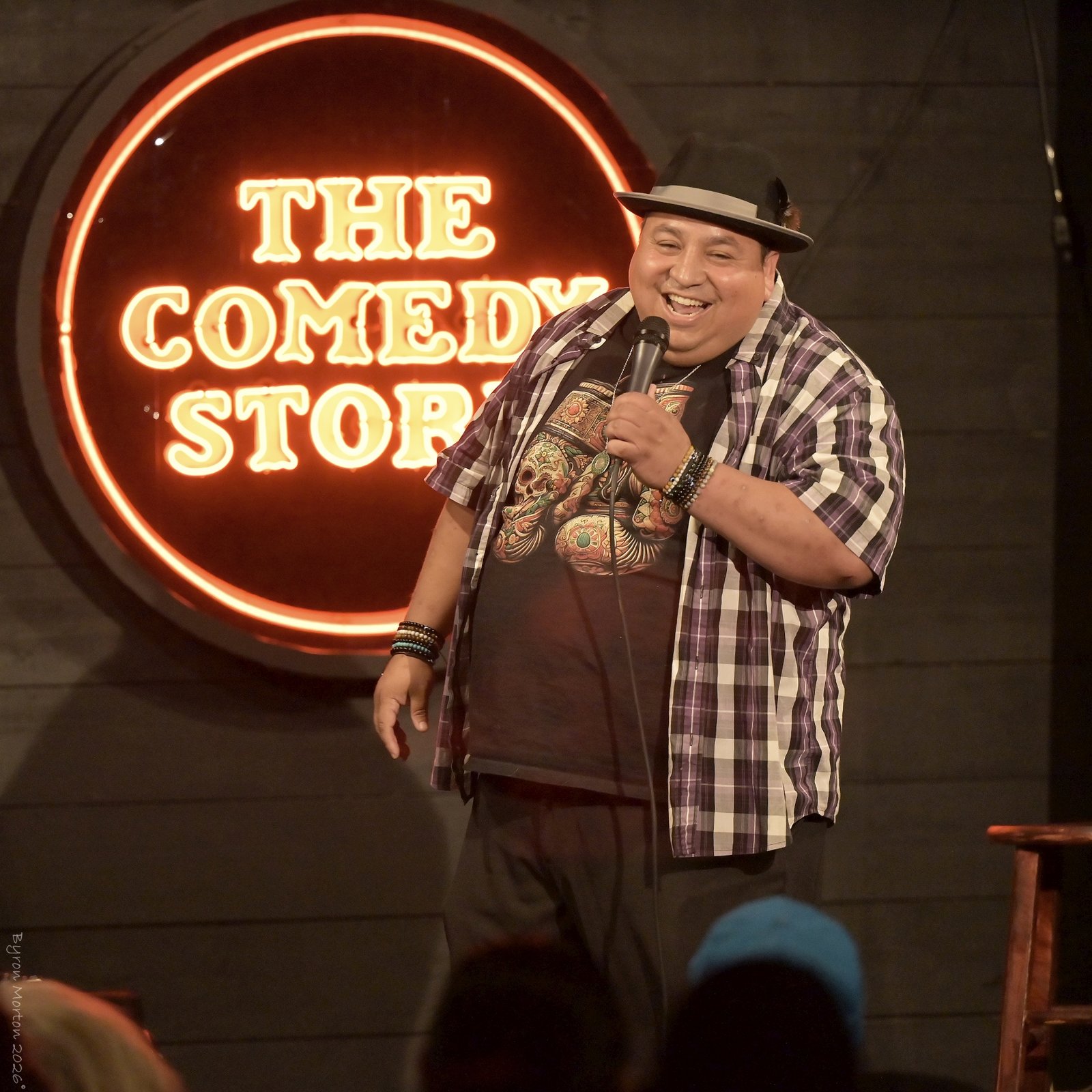 Victor Paz Jr laughing on stage at The Comedy Store La Jolla